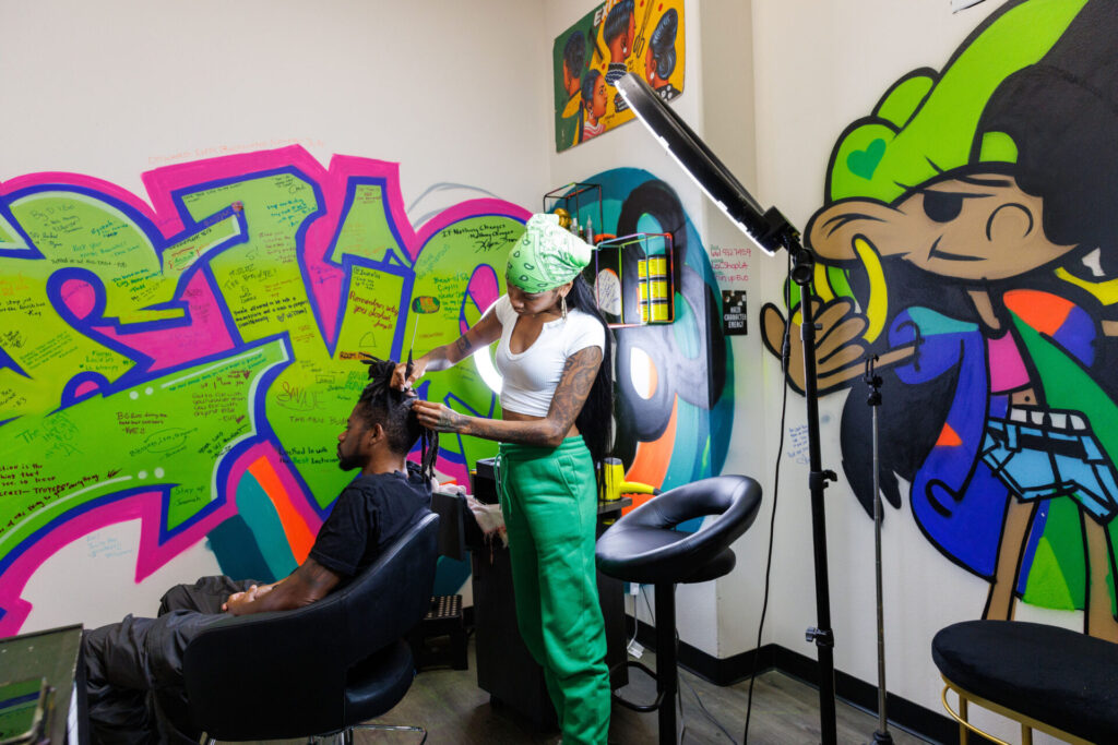 Hair salon with vibrant graffiti art wall.